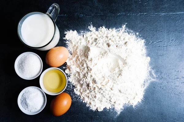 Baking powder milk and eggs on chalkboard for background