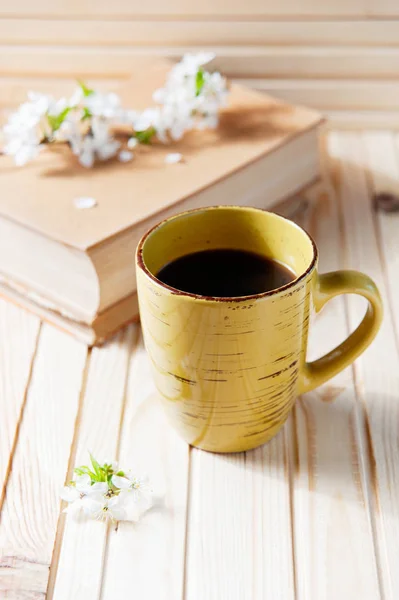 Romantic background with cup of tea , flowers and book over white table — Stock Photo, Image