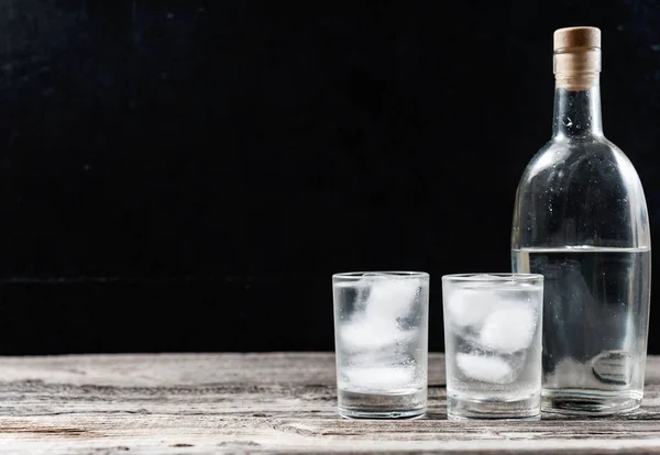 Vodka froide dans des verres de tir sur un fond noir — Photo