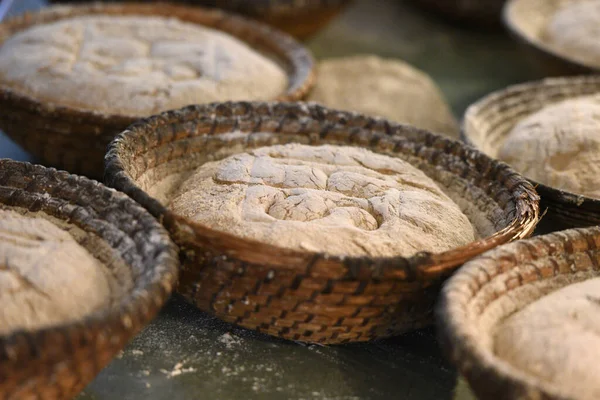 Bread dough in baking tins before being put in the oven.