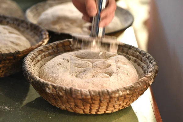 Bread dough in baking tins before being put in the oven.