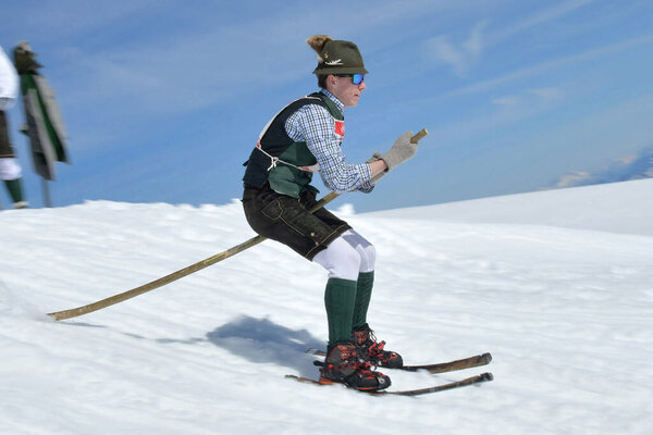Quaint barrel stave race - barrel staves are the curved boards that give shape and hold to a barrel. A leather strap is the only hold for the "skier" - and a mountain stick. You need a lot of acrobatic skill to drive