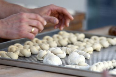 Pasta parçaları bir yemek tepsisi üzerinde şekillenir..