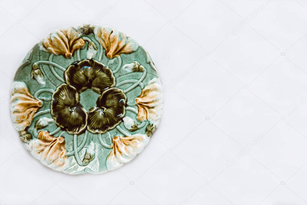 Vintage plate with patterns on a background of hay