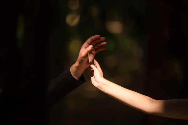 Guy and girl touch hands in romantic.