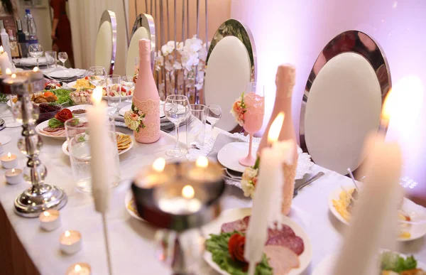 Burning candles on a wedding table.