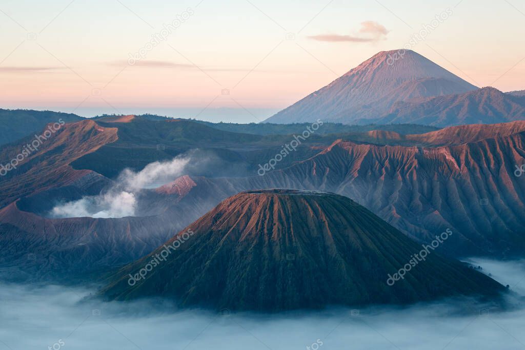 Bromo volcano on Java island, Indonesia. Foggy sunrise, another planet landscape