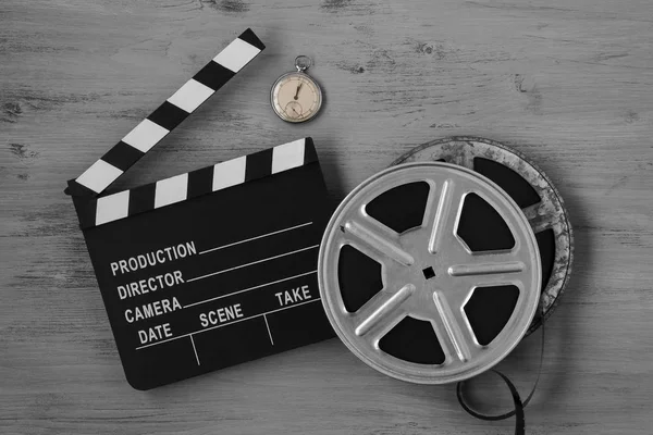 Clapperboards , two film reels and old clock — Stock Photo, Image
