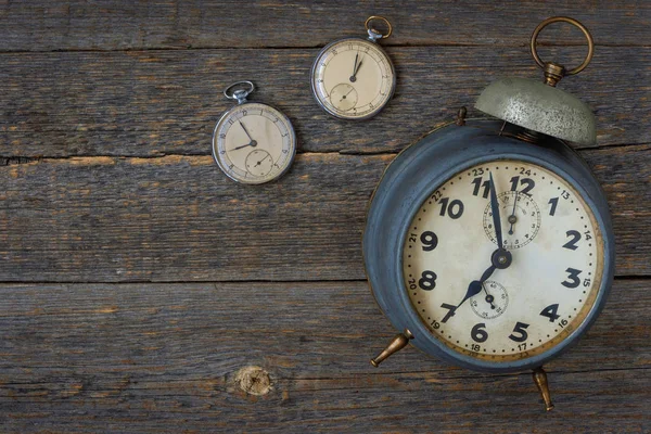 Old pocket watch and alarm clock Stock Photo