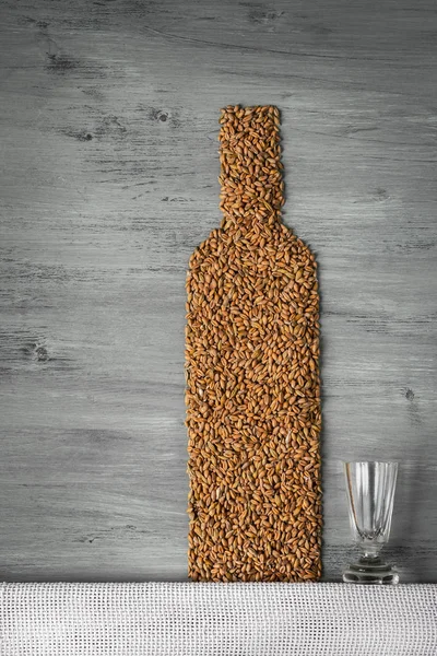 Grains and alcohol bottle — Stock Photo, Image