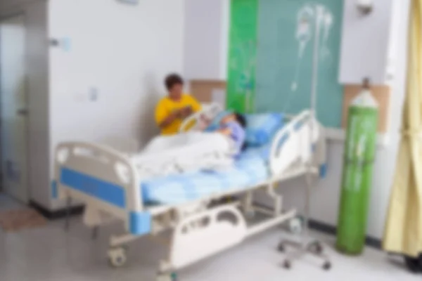 Blurred image of a patient lying on a bed in the hospital for IV