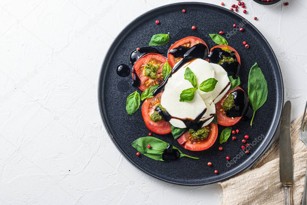 Caprese salad with cherry kumato tomatoes with black pepper. Close up. top view space for text