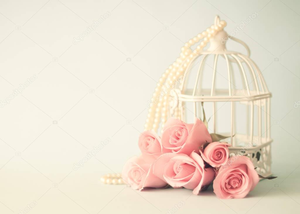 Bird cage and roses
