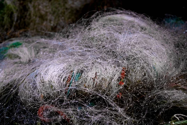 nylon fishing nets with drops of water and colored ropes