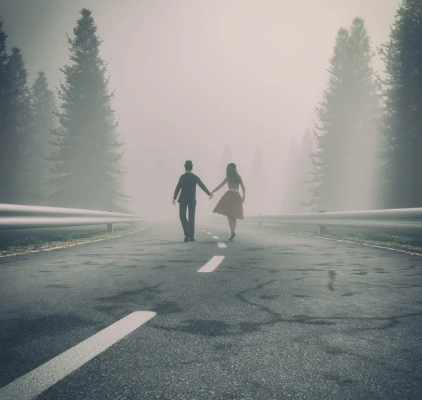 Couple walking  on a forest road — Stock Photo, Image