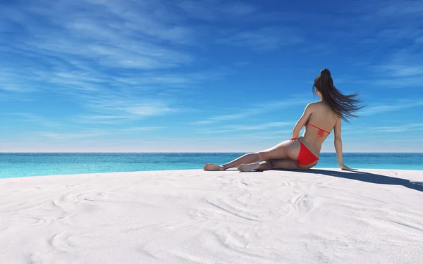 Vrouw op het zand aan de kust — Stockfoto