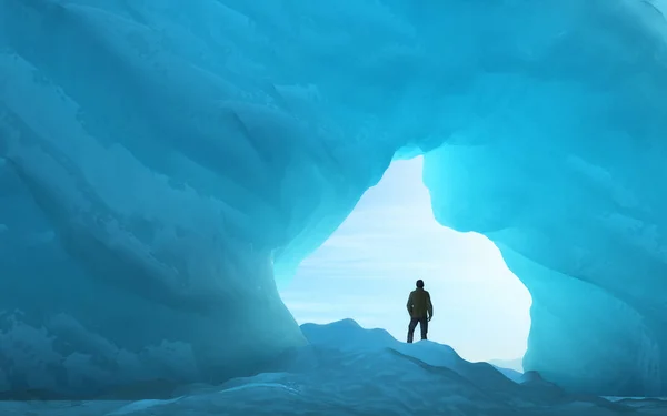 Young man under an ice arch — Stock Photo, Image