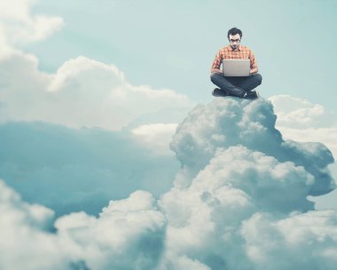 Dizüstü bilgisayarda çalışan genç ve bulut üzerine