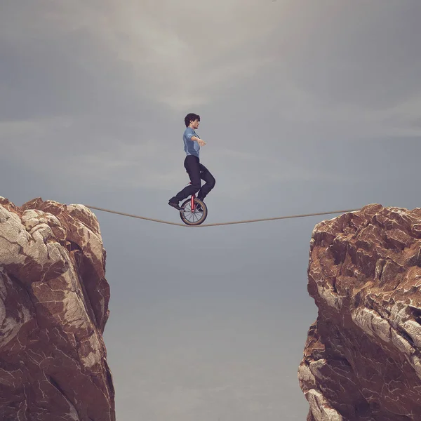 Man pedaling on rope between two mountains — Stock Photo, Image