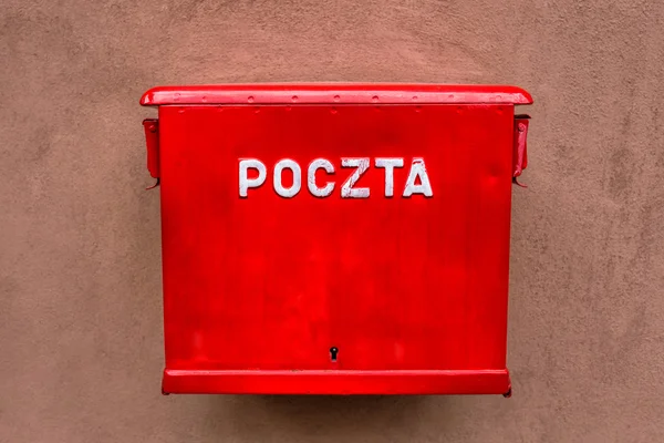 Red mailbox hanging on the wall in Poland — Stock Photo, Image