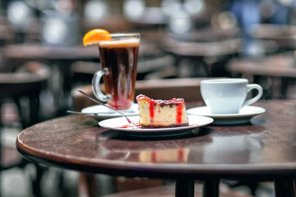 Slice of cheesecake with cherry and cup tea — Stock Photo, Image