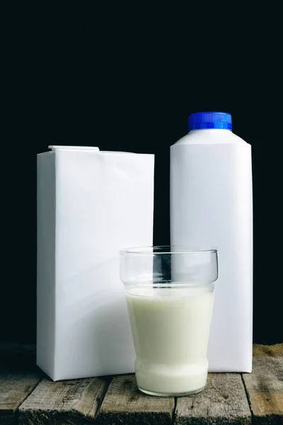 Glass with fresh organic milk and white drinking straw