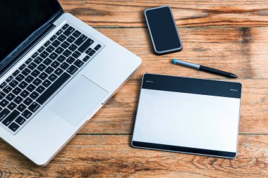 Ahşap arka plan üzerinde dizüstü klavye ile çalışma alanı. Yukarıdan görüntülemek