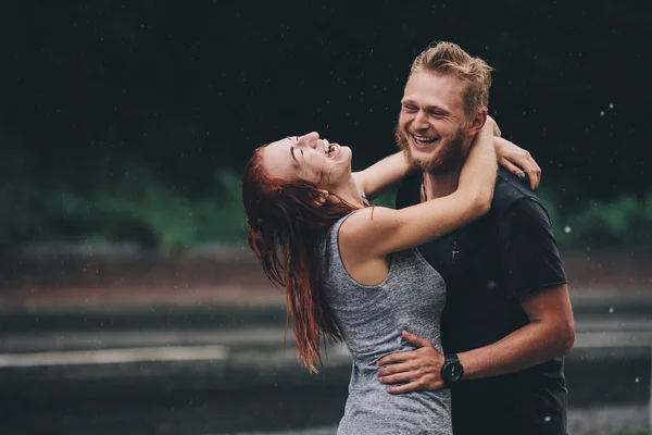 Beautiful couple hugging in the rain — Stock Photo, Image