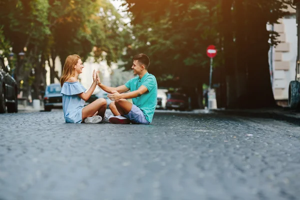 Paar sitzt auf Gehweg — Stockfoto