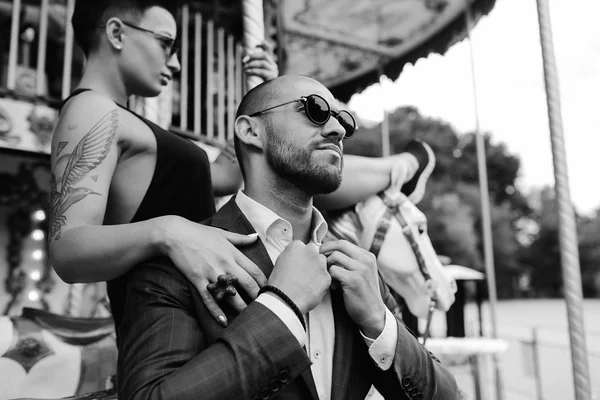 Adult man and woman on a carousel — Stock Photo, Image