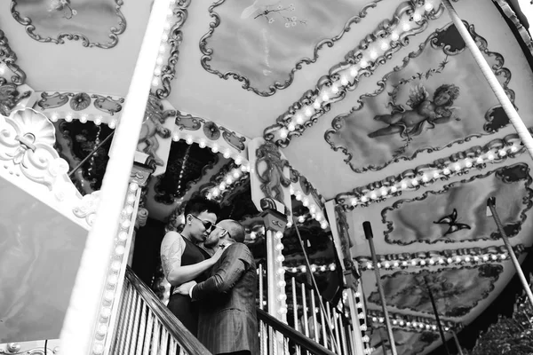 Adult man and woman on a carousel — Stock Photo, Image