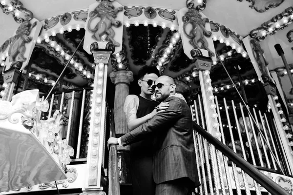 Adult man and woman on a carousel — Stock Photo, Image