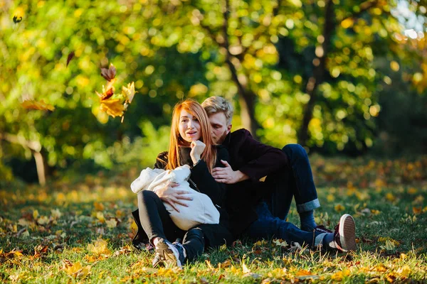 Young family and newborn son in autumn park — Stock Photo, Image