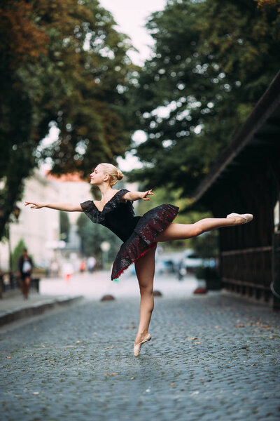 Ballerina posing in the center city