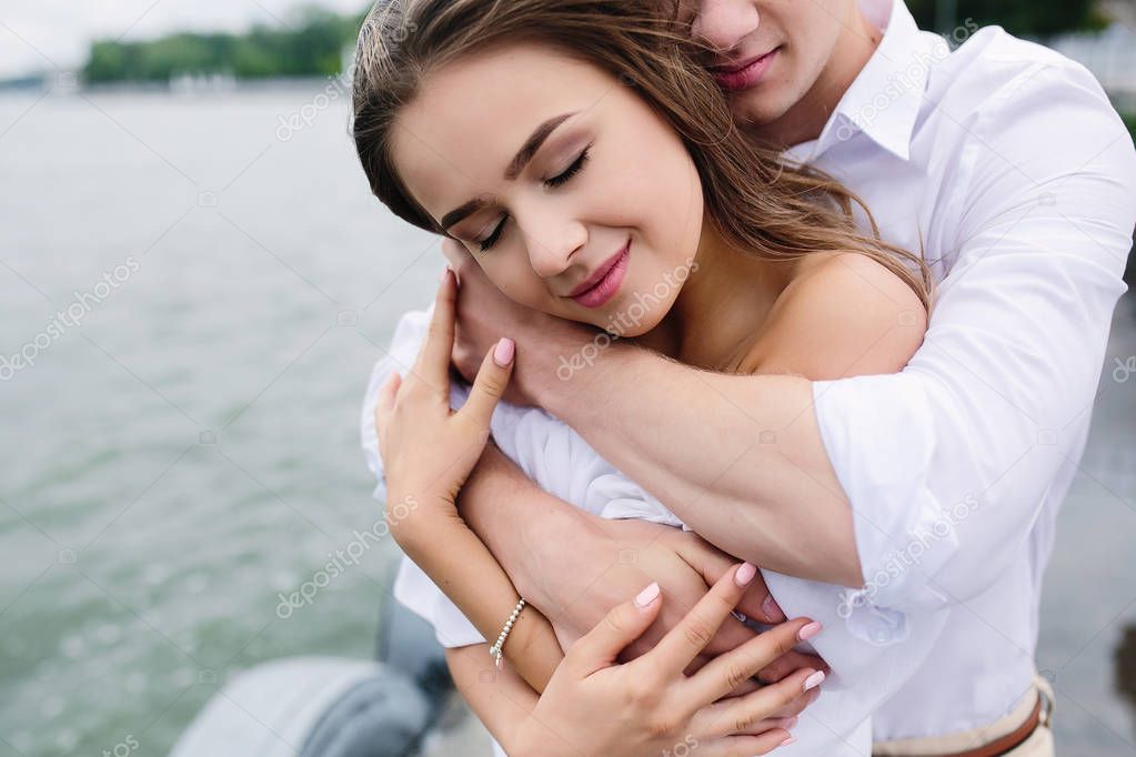 man and woman posing on the lake