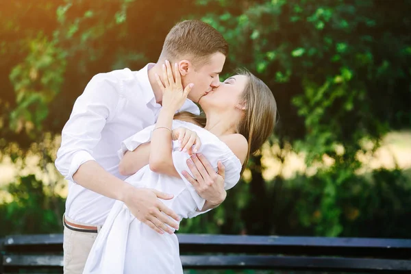 Young brunette man and woman in the park — Stock Photo, Image