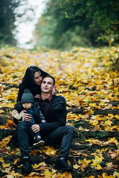 Young family and newborn son in autumn park — Stock Photo, Image