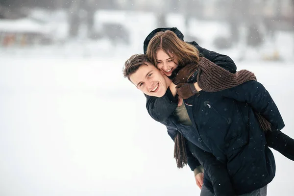 Man carries his girlfriend on the back — Stock Photo, Image