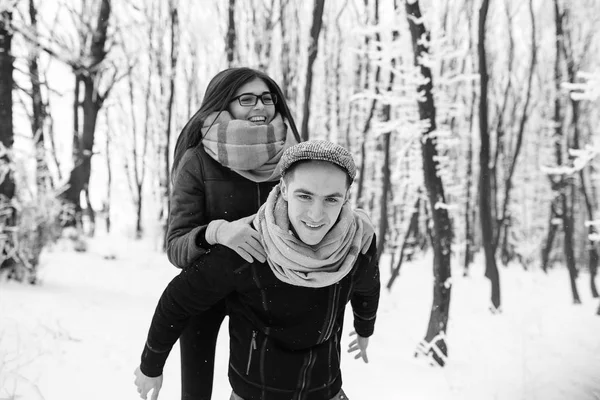 Happy couple playful together in snow park