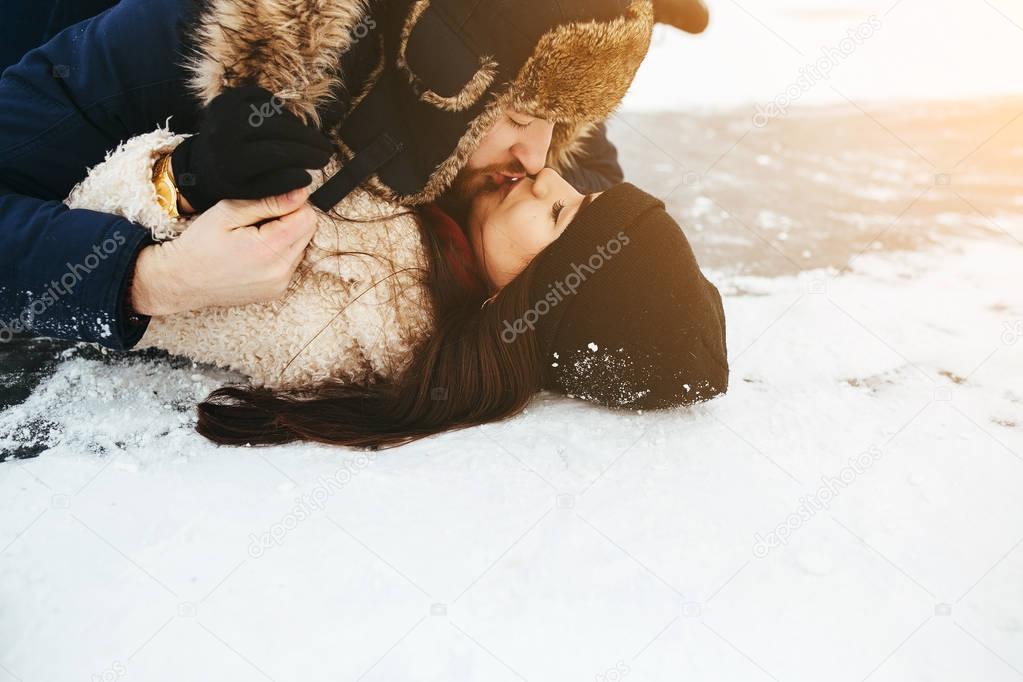 man and woman kiss on ice