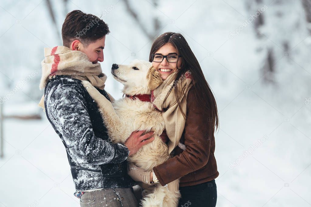 Young couple having fun in winter park