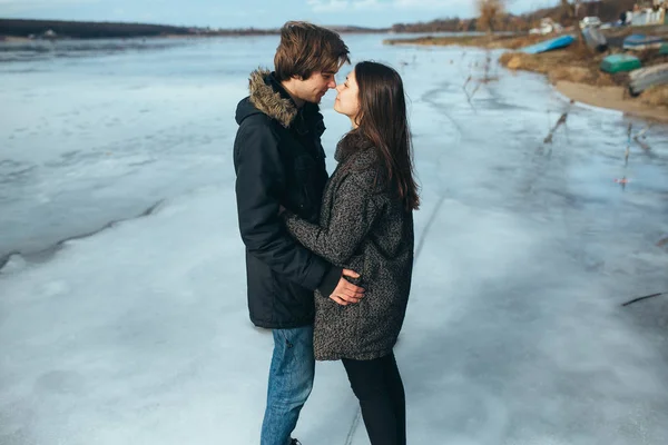 年轻美丽的情侣在冰上结冰的湖面 — 图库照片