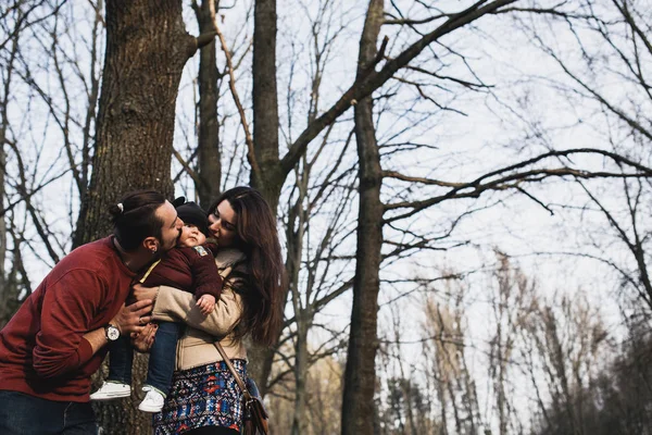 Young family and son in autumn park — Stock Photo, Image