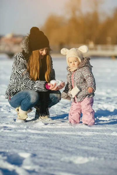 mother and daughter in winter outdoors