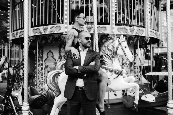 Adult man and woman on a carousel — Stock Photo, Image