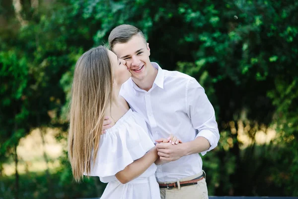 Young brunette man and woman in the park — Stock Photo, Image