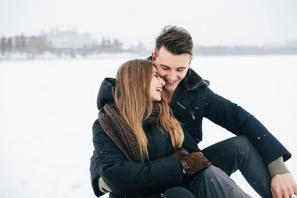 couple sitting on the snow