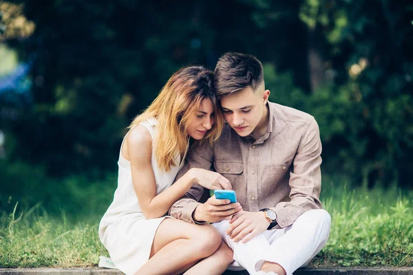 Ascot parkta oturan bir smartphone kullanarak