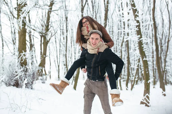 Happy couple playful together in snow park