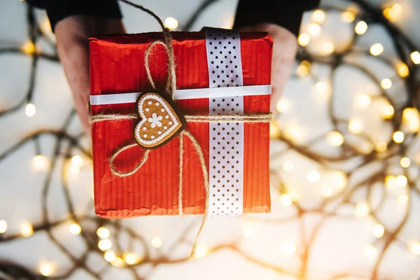 Girl holding a Christmas gift in hand — Stock Photo, Image